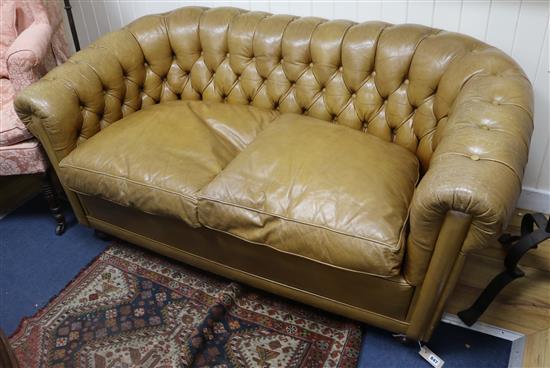 A small buttoned leather Chesterfield sofa W.150cm